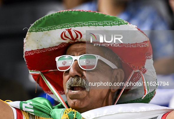 A fan of Esteghlal FC cheers for their team during the AFC Champions League elite west football match between Qatar's Al Sadd SC and Iran's...