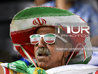 A fan of Esteghlal FC cheers for their team during the AFC Champions League elite west football match between Qatar's Al Sadd SC and Iran's...