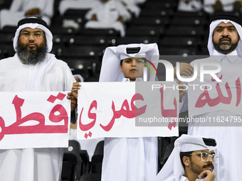 Fans of Al Sadd SC cheer for their team during the AFC Champions League elite west football match between Qatar's Al Sadd SC and Iran's Este...