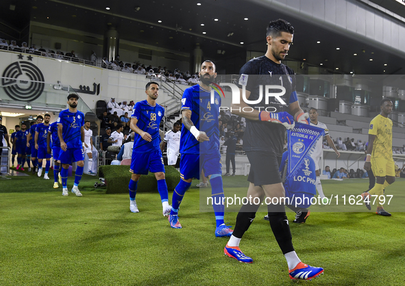 Esteghlal FC and Al Sadd SC players walk onto the pitch before the AFC Champions League elite west football match between Qatar's Al Sadd SC...