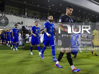 Esteghlal FC and Al Sadd SC players walk onto the pitch before the AFC Champions League elite west football match between Qatar's Al Sadd SC...