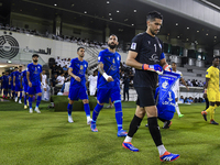 Esteghlal FC and Al Sadd SC players walk onto the pitch before the AFC Champions League elite west football match between Qatar's Al Sadd SC...