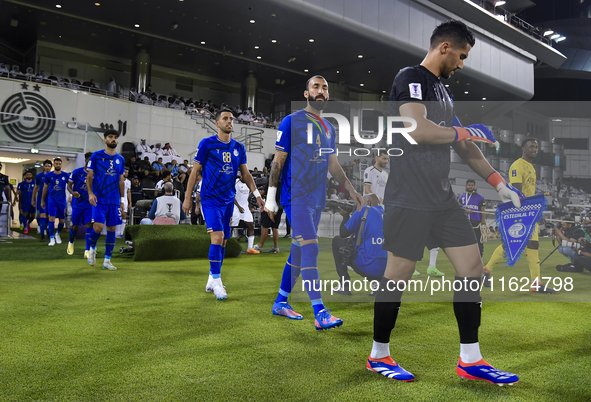 Esteghlal FC and Al Sadd SC players walk onto the pitch before the AFC Champions League elite west football match between Qatar's Al Sadd SC...