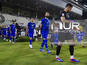 Esteghlal FC and Al Sadd SC players walk onto the pitch before the AFC Champions League elite west football match between Qatar's Al Sadd SC...