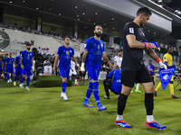 Esteghlal FC and Al Sadd SC players walk onto the pitch before the AFC Champions League elite west football match between Qatar's Al Sadd SC...