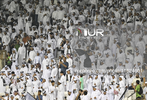 Fans of Al Sadd SC cheer for their team during the AFC Champions League elite west football match between Qatar's Al Sadd SC and Iran's Este...