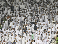 Fans of Al Sadd SC cheer for their team during the AFC Champions League elite west football match between Qatar's Al Sadd SC and Iran's Este...