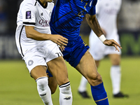 Youcef Atal of Al Sadd SC battles for the ball with Saman Fallah of Esteghlal FC during the AFC Champions League elite west football match b...