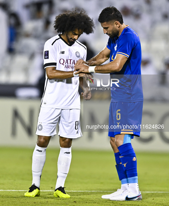 Akram Hassan Afif of Al Sadd SC and Iman Salimi of Esteghlal FC react during the AFC Champions League elite west football match between Qata...