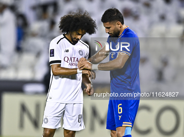 Akram Hassan Afif of Al Sadd SC and Iman Salimi of Esteghlal FC react during the AFC Champions League elite west football match between Qata...