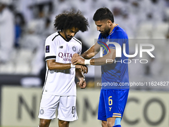 Akram Hassan Afif of Al Sadd SC and Iman Salimi of Esteghlal FC react during the AFC Champions League elite west football match between Qata...