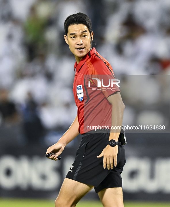 South Korean referee Kim Jong Hyeok gestures during the AFC Champions League elite west football match between Qatar's Al Sadd SC and Iran's...