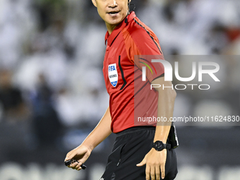 South Korean referee Kim Jong Hyeok gestures during the AFC Champions League elite west football match between Qatar's Al Sadd SC and Iran's...