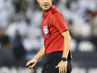 South Korean referee Kim Jong Hyeok gestures during the AFC Champions League elite west football match between Qatar's Al Sadd SC and Iran's...