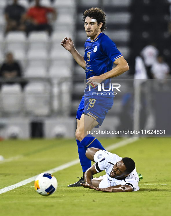 Pedro Miguel Correia (bottom) of Al Sadd SC battles for the ball with Gustavo Blanco of Esteghlal FC during the AFC Champions League elite w...