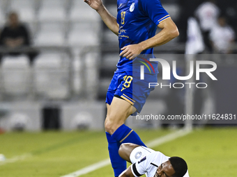 Pedro Miguel Correia (bottom) of Al Sadd SC battles for the ball with Gustavo Blanco of Esteghlal FC during the AFC Champions League elite w...