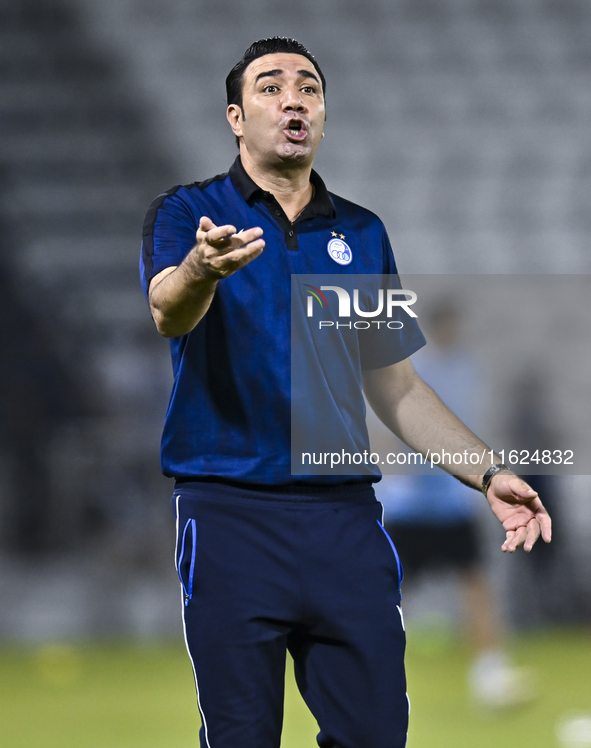 Esteghlal FC Head Coach, Javad Nekounam, reacts during the AFC Champions League elite west football match between Qatar's Al Sadd SC and Ira...