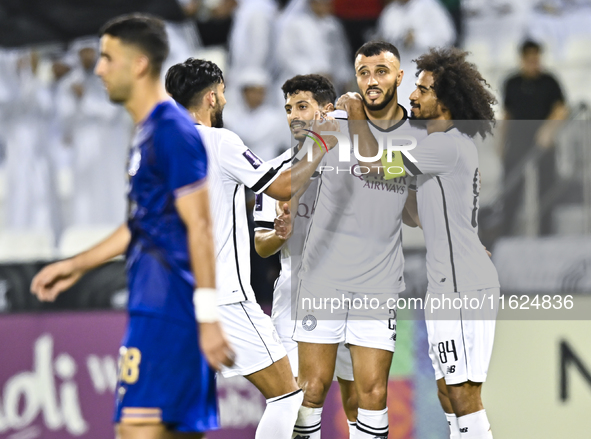 Akram Hassan Afif (R) and Romain Saiss (C) of Al Sadd SC celebrate their team's first goal, an own goal by Hossein Hosseini of Esteghlal FC,...