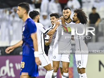 Akram Hassan Afif (R) and Romain Saiss (C) of Al Sadd SC celebrate their team's first goal, an own goal by Hossein Hosseini of Esteghlal FC,...