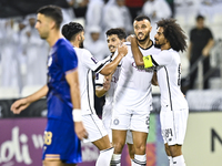 Akram Hassan Afif (R) and Romain Saiss (C) of Al Sadd SC celebrate their team's first goal, an own goal by Hossein Hosseini of Esteghlal FC,...