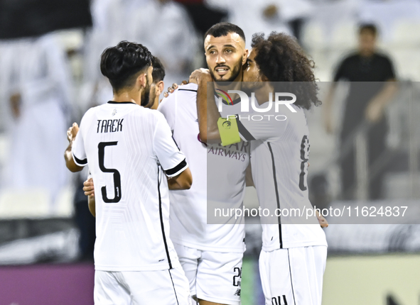 Akram Hassan Afif (R) and Romain Saiss (C) of Al Sadd SC celebrate their team's first goal, an own goal by Hossein Hosseini of Esteghlal FC,...