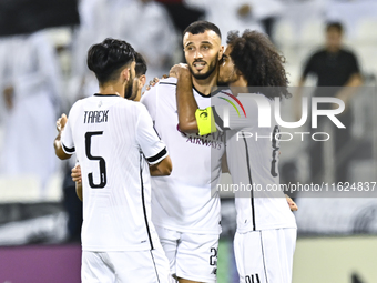 Akram Hassan Afif (R) and Romain Saiss (C) of Al Sadd SC celebrate their team's first goal, an own goal by Hossein Hosseini of Esteghlal FC,...