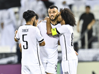 Akram Hassan Afif (R) and Romain Saiss (C) of Al Sadd SC celebrate their team's first goal, an own goal by Hossein Hosseini of Esteghlal FC,...