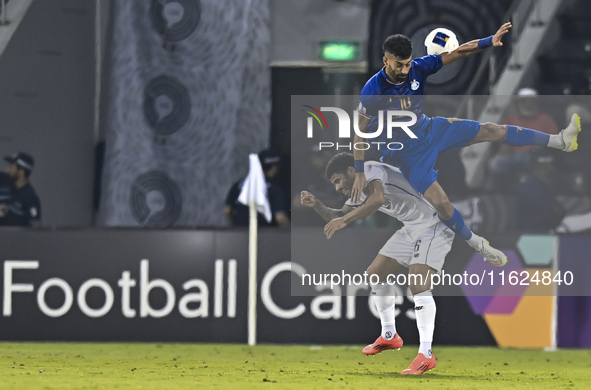 Paulo Silva (L) of Al Sadd SC and Ramin Rezaeian (top) of Esteghlal FC are in action during the AFC Champions League elite west football mat...