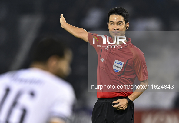 South Korean referee Kim Jong Hyeok gestures during the AFC Champions League elite west football match between Qatar's Al Sadd SC and Iran's...