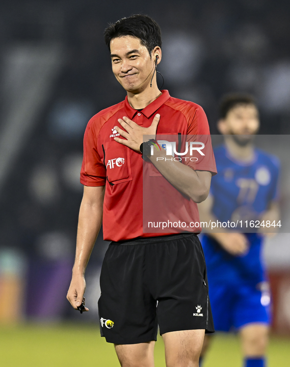 South Korean referee Kim Jong Hyeok gestures during the AFC Champions League elite west football match between Qatar's Al Sadd SC and Iran's...