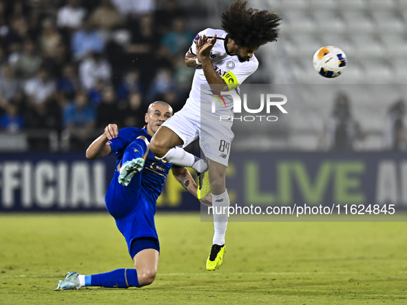 Akram Hassan Afif (R) of Al Sadd SC and Raphael Da Silva of Esteghlal FC are in action during the AFC Champions League elite west football m...