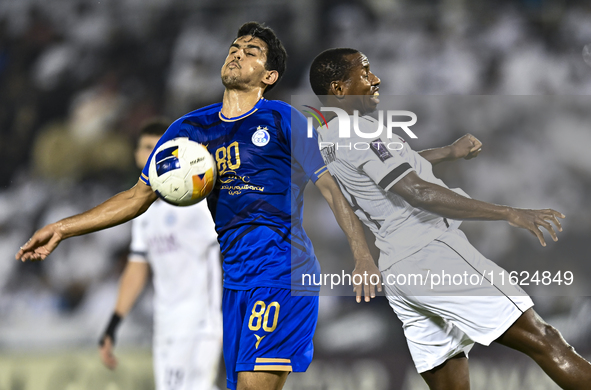 Mohamed Camara (R) of Al Sadd SC battles for the ball with Mohammadhossein Eslami of Esteghlal FC during the AFC Champions League elite west...