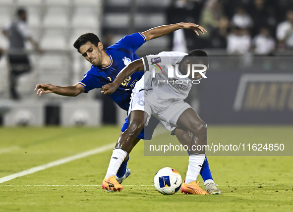 Mohamed Camara (R) of Al Sadd SC battles for the ball with Mohammadhossein Eslami of Esteghlal FC during the AFC Champions League elite west...