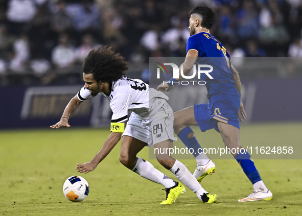 Akram Hassan Afif of Al Sadd SC battles for the ball with Ramin Rezaeian of Esteghlal FC during the AFC Champions League elite west football...