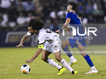 Akram Hassan Afif of Al Sadd SC battles for the ball with Ramin Rezaeian of Esteghlal FC during the AFC Champions League elite west football...