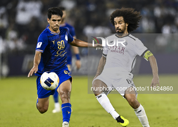 Akram Hassan Afif (R) of Al Sadd SC battles for the ball with Mohammadhossein Eslami of Esteghlal FC during the AFC Champions League elite w...