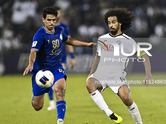 Akram Hassan Afif (R) of Al Sadd SC battles for the ball with Mohammadhossein Eslami of Esteghlal FC during the AFC Champions League elite w...