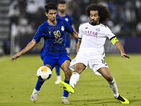 Akram Hassan Afif (R) of Al Sadd SC battles for the ball with Mohammadhossein Eslami of Esteghlal FC during the AFC Champions League elite w...