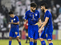 Players of Esteghlal FC express their dejection after the AFC Champions League elite west football match between Qatar's Al Sadd SC and Iran...