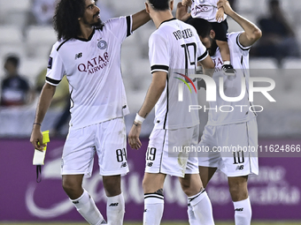 Akram Hassan Afif (L), Rafael Sebastian Mujica Garcia (C), and Hasan Khalid Alhaydos (R) of Al Sadd SC celebrate after winning the AFC Champ...