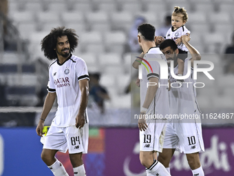 Akram Hassan Afif (L), Rafael Sebastian Mujica Garcia (C), and Hasan Khalid Alhaydos (R) of Al Sadd SC celebrate after winning the AFC Champ...