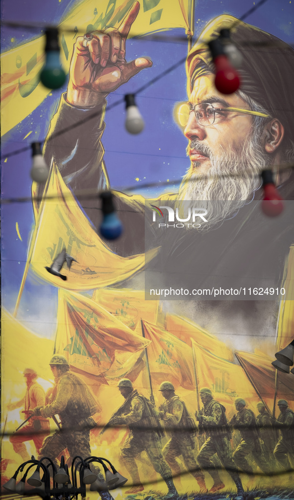 A giant banner featuring a portrait of Lebanon's Hezbollah Secretary General, Hassan Nasrallah, who was killed in an Israeli air strike in t...