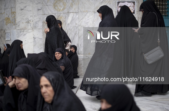 Veiled Iranian women participate in a protest gathering to condemn the Israeli air strike against Hezbollah's headquarters in the suburb of...