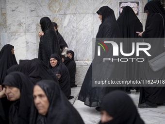 Veiled Iranian women participate in a protest gathering to condemn the Israeli air strike against Hezbollah's headquarters in the suburb of...