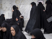 Veiled Iranian women participate in a protest gathering to condemn the Israeli air strike against Hezbollah's headquarters in the suburb of...