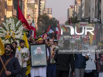 Iranian protesters carry portraits of Lebanon's Hezbollah Secretary General, Hassan Nasrallah, and an Islamic Revolutionary Guard Corps' (IR...