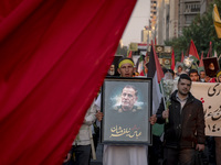 An Iranian protester carries a portrait of Islamic Revolutionary Guard Corps' (IRGC) Quds Force commander, General Abbas Nilforoushan, durin...