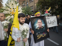 An Iranian protester carries a portrait of Islamic Revolutionary Guard Corps' (IRGC) Quds Force commander, General Abbas Nilforoushan, durin...