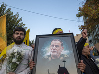 An Iranian protester carries a portrait of Islamic Revolutionary Guard Corps' (IRGC) Quds Force commander, General Abbas Nilforoushan, durin...