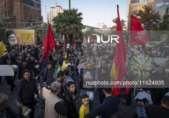 An Iranian protester carries a portrait of Islamic Revolutionary Guard Corps' (IRGC) Quds Force commander, General Abbas Nilforoushan, durin...